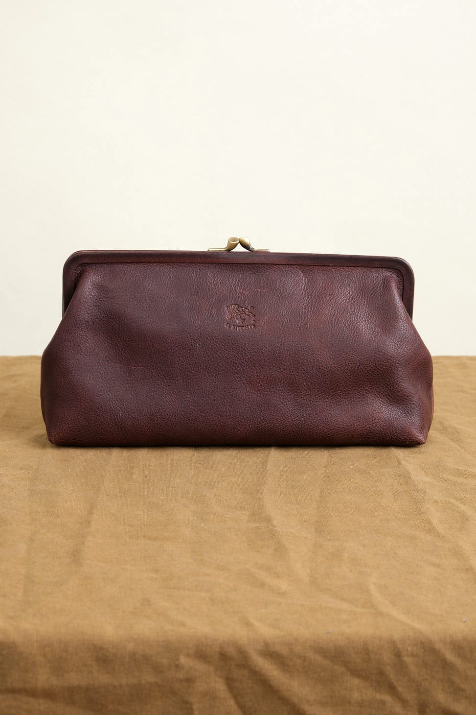 Manuela Classic Clutch Bag in Caffe on table