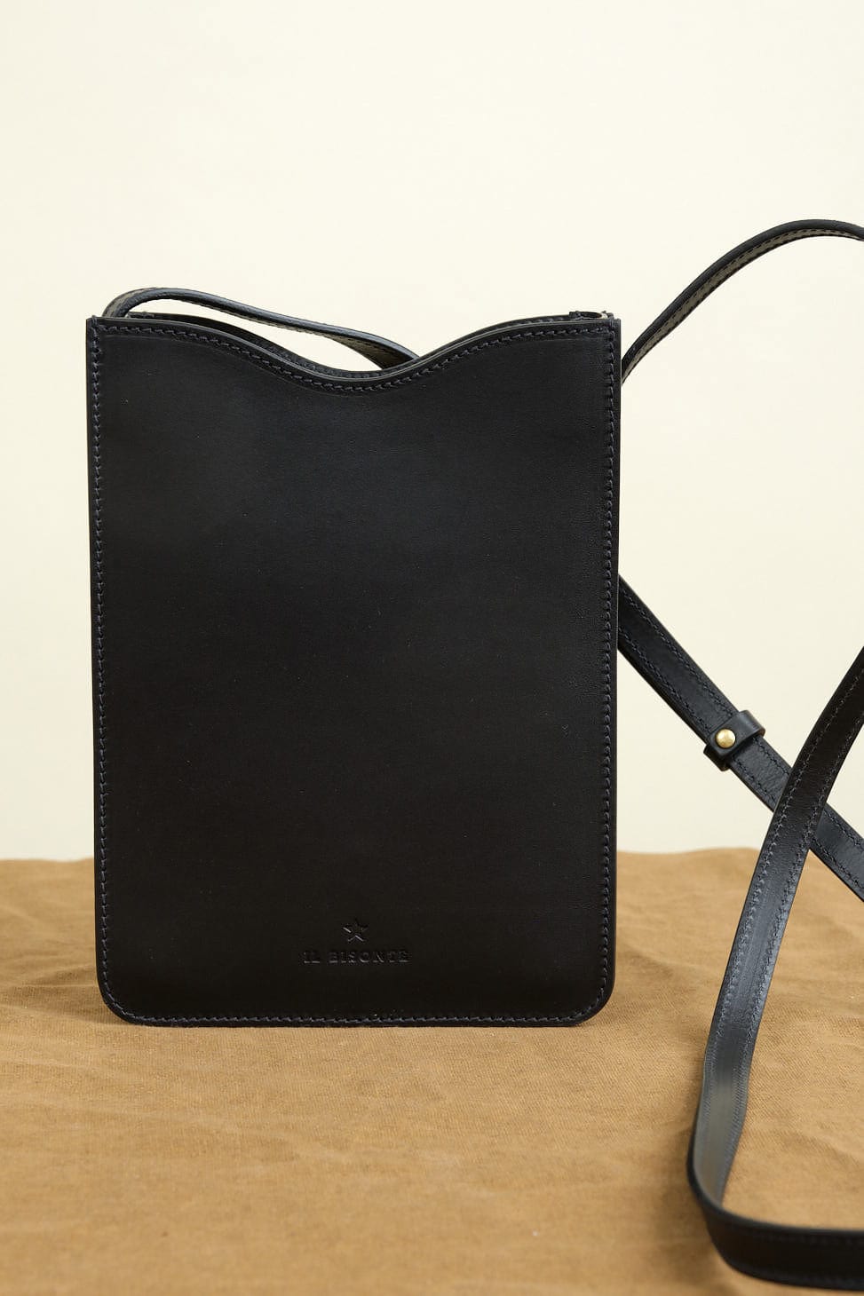 Roseto Crossbody Bag in Nero on table