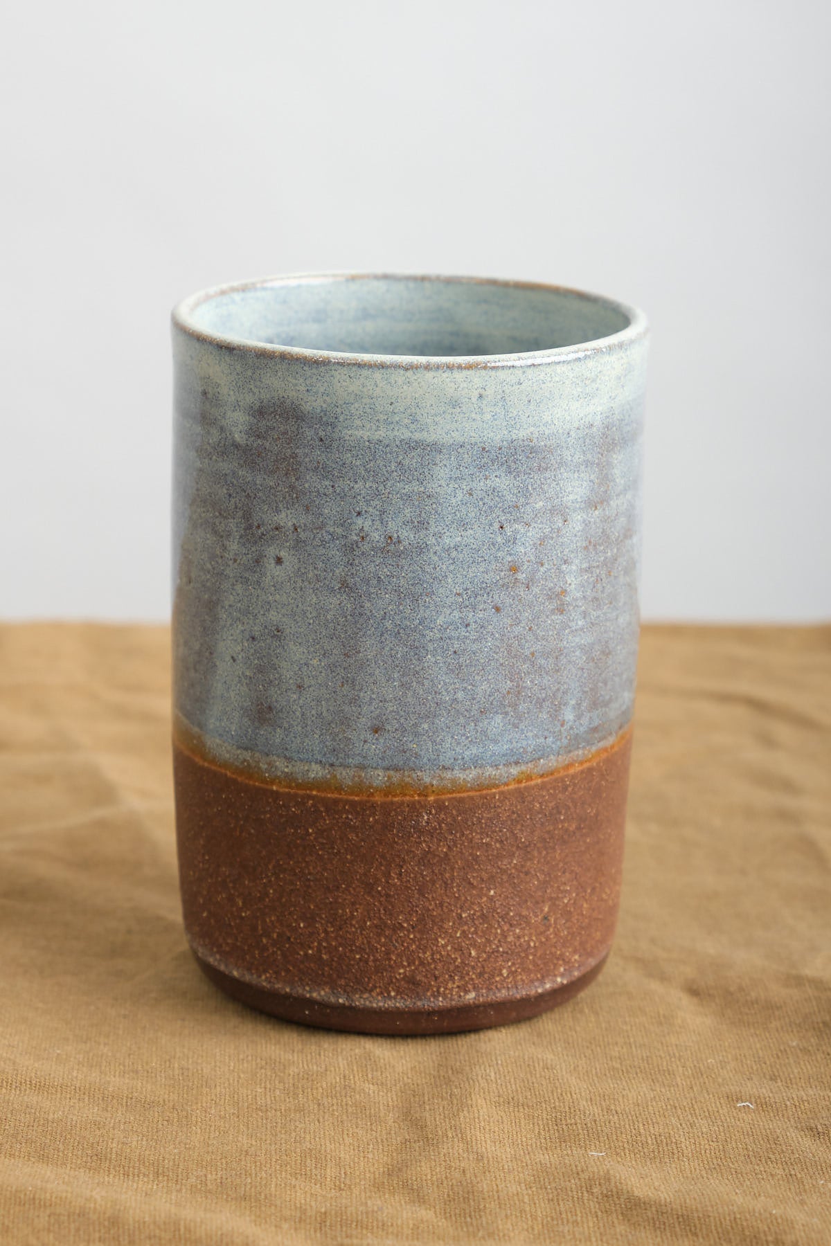 Kati Von Lehman Tumbler in Brownstone with natural base and  Shino glaze on top  