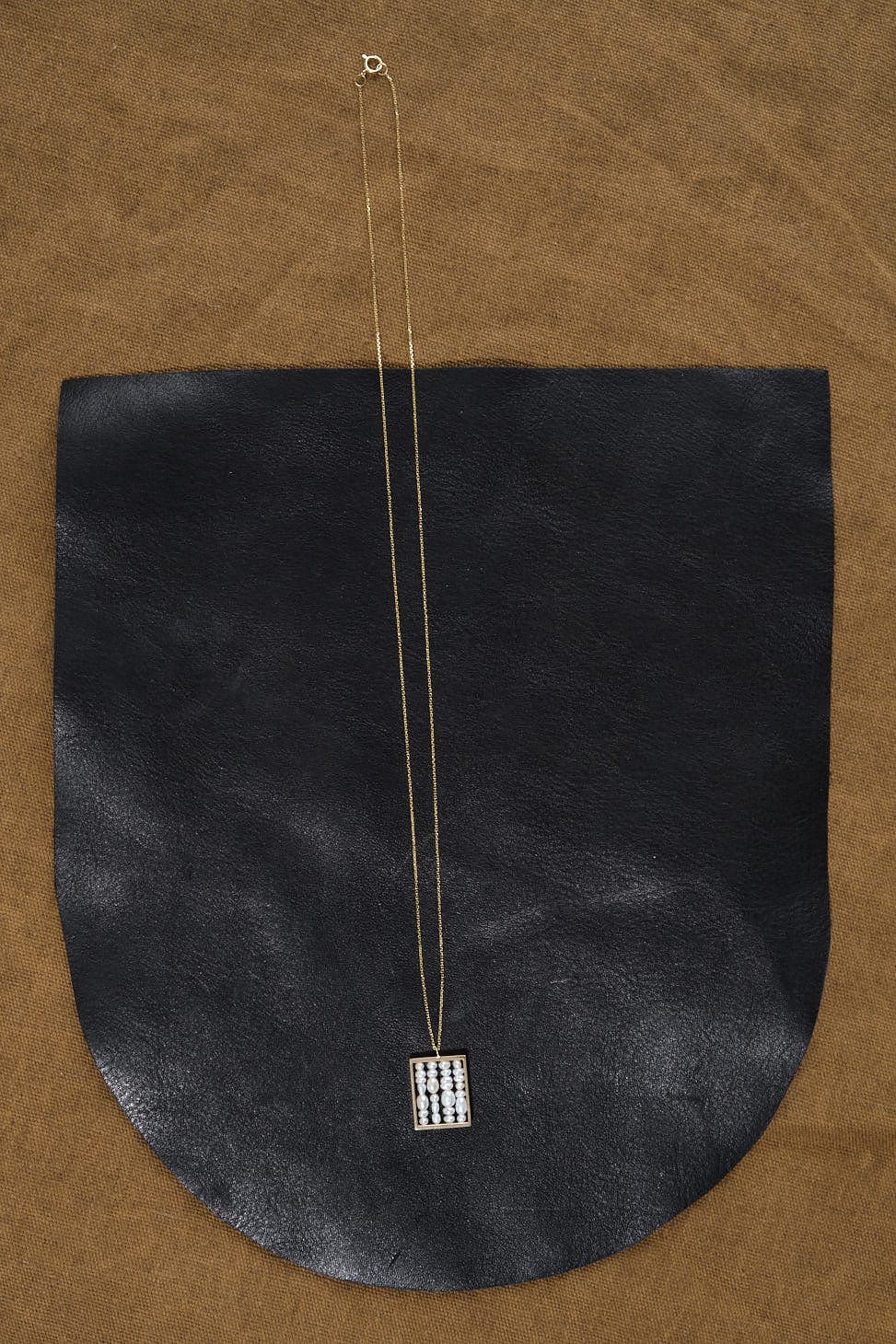 Small Weaving Necklace on table