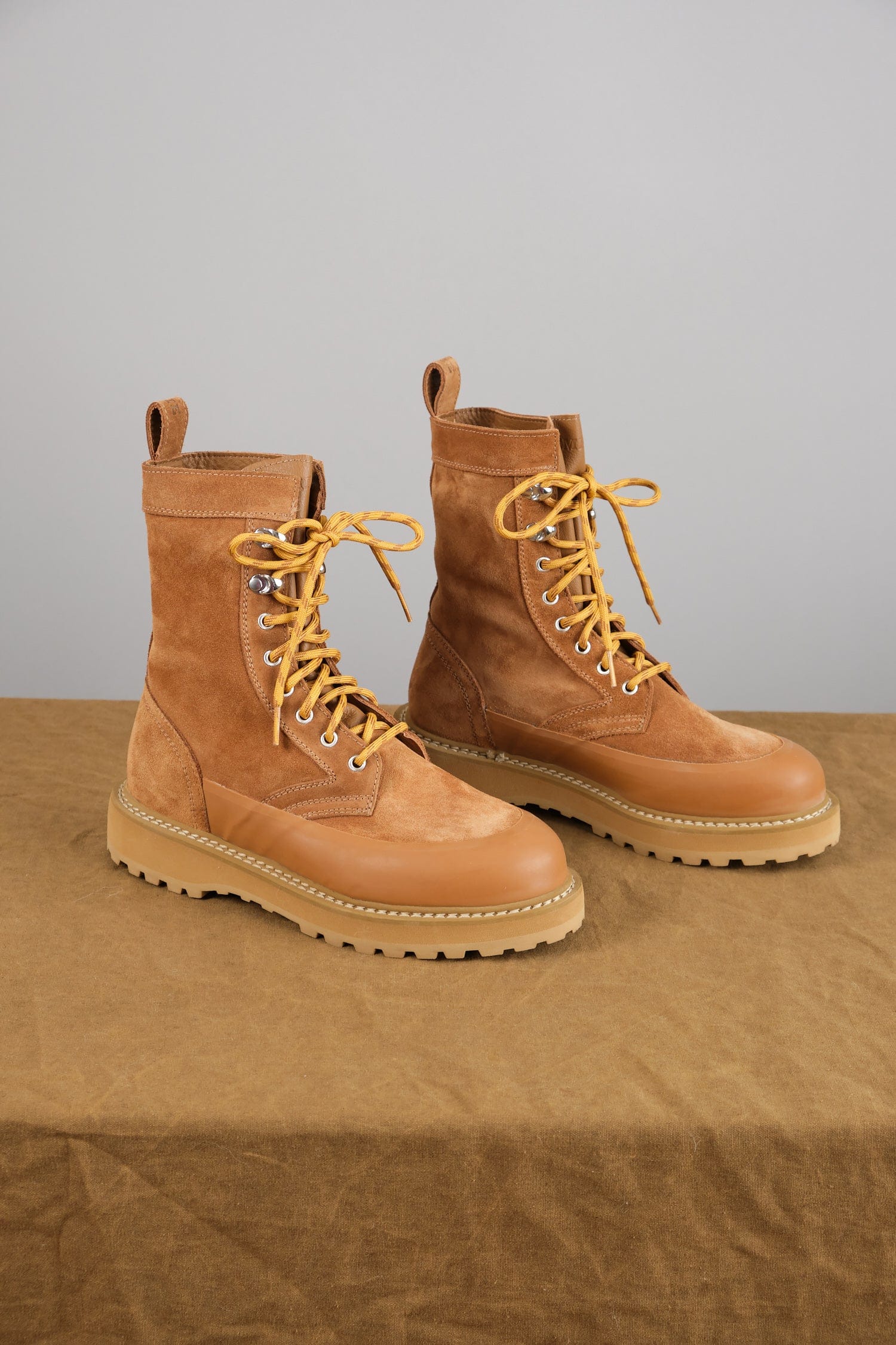 Altivole Due Boot in Cognac Suede on table