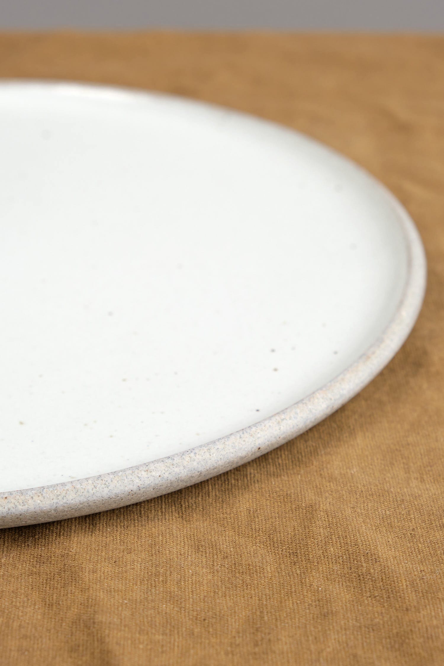 Side of 11" Stillness Plate in Greystone/Snow White