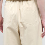 Back pocket view of Signature Curve Legged Trouser in Off White