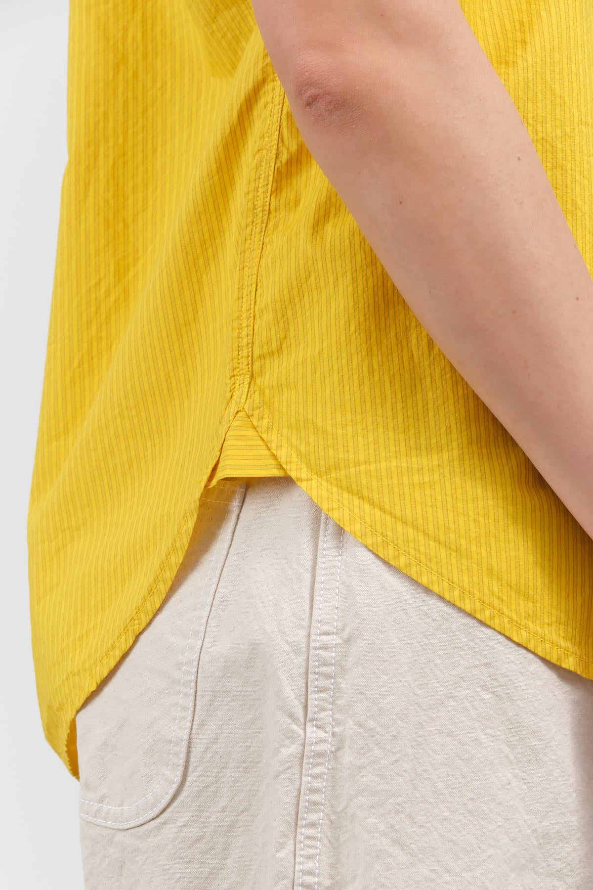 Side hem view of Ruth Sleeveless Shirt in Lemon