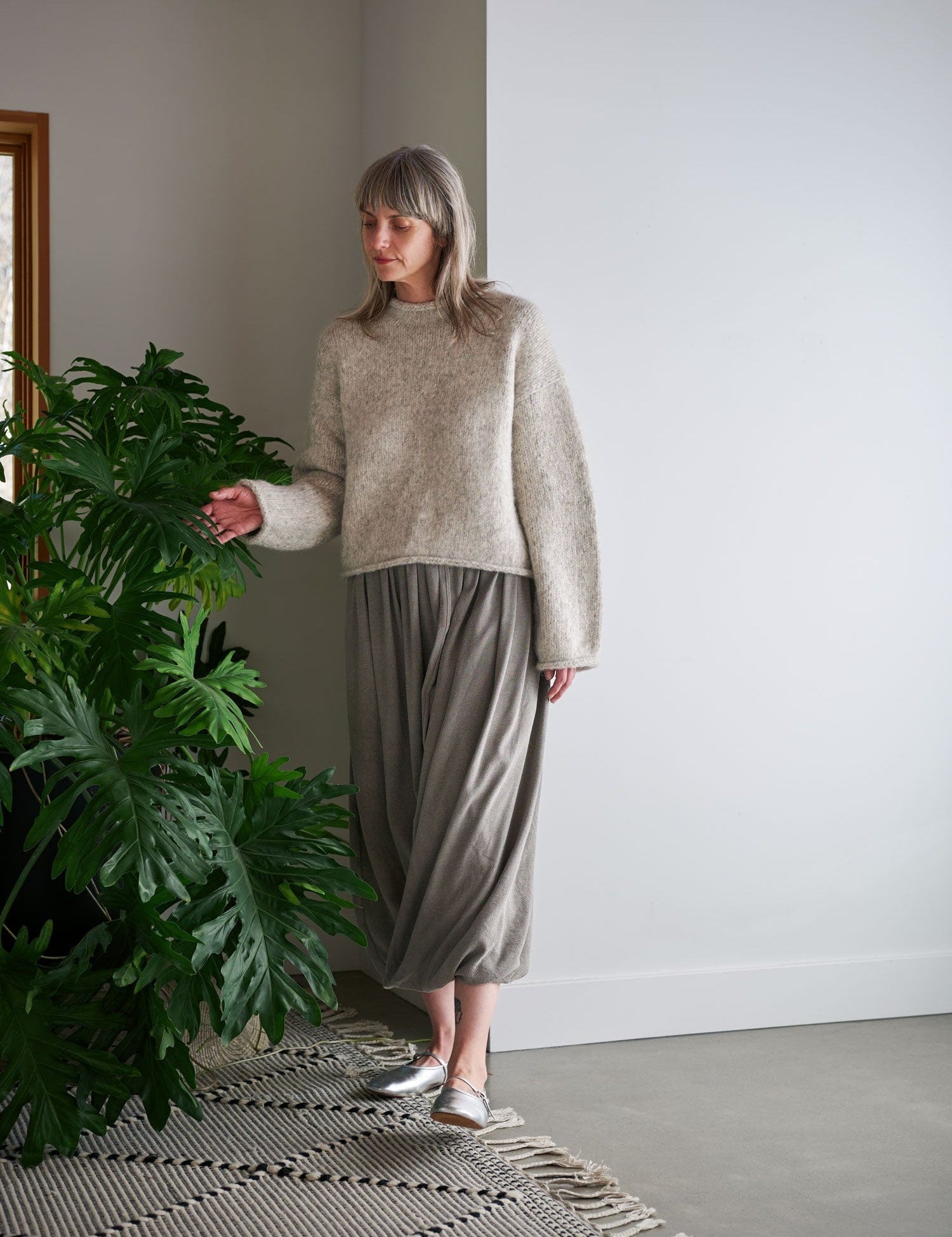 Women wearing black crane outfit in a cozy home.