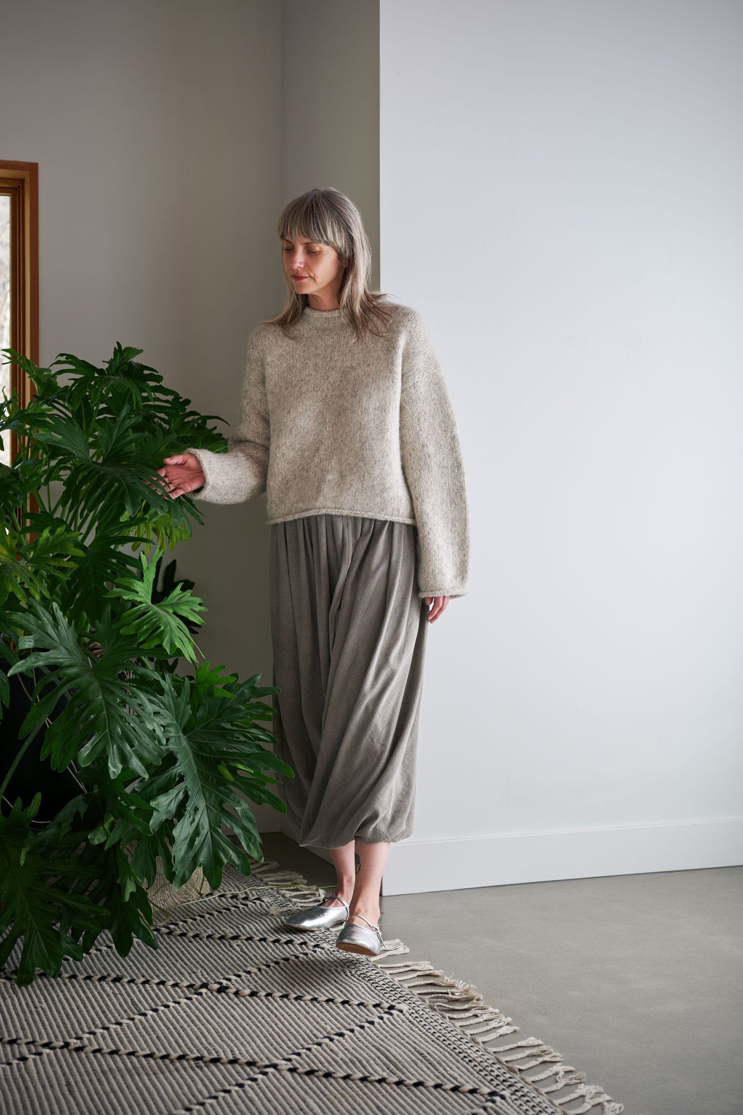 Women wearing black crane outfit in a cozy home.