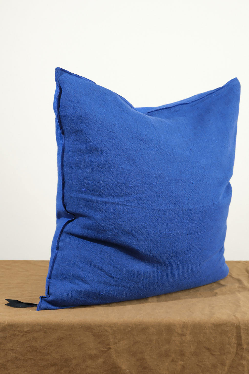 Angle view of 26" X 26" Crumpled Washed Linen Vice Versa Cushion in Cobalt