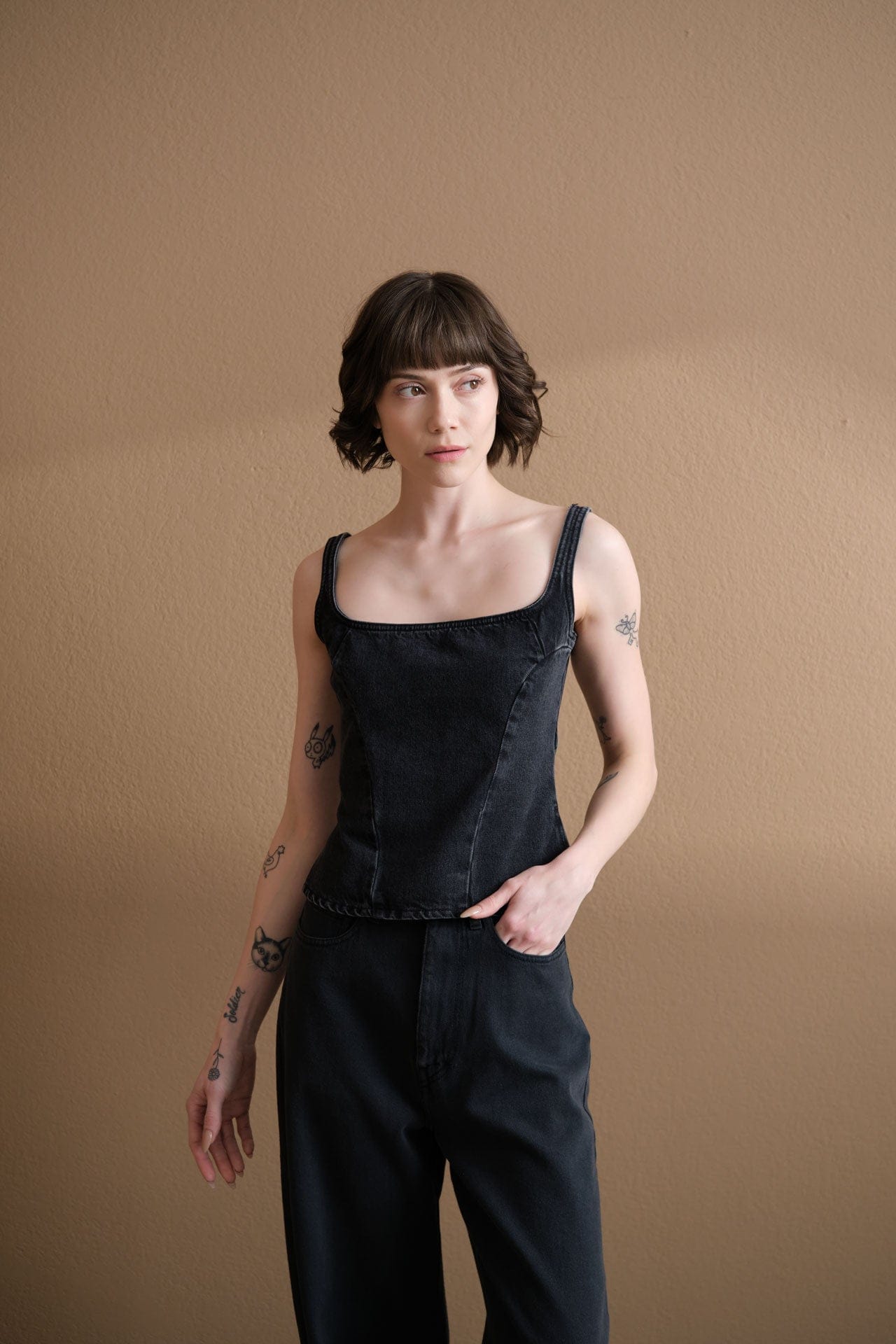 Woman wearing Dala Quiet Corset denim top.