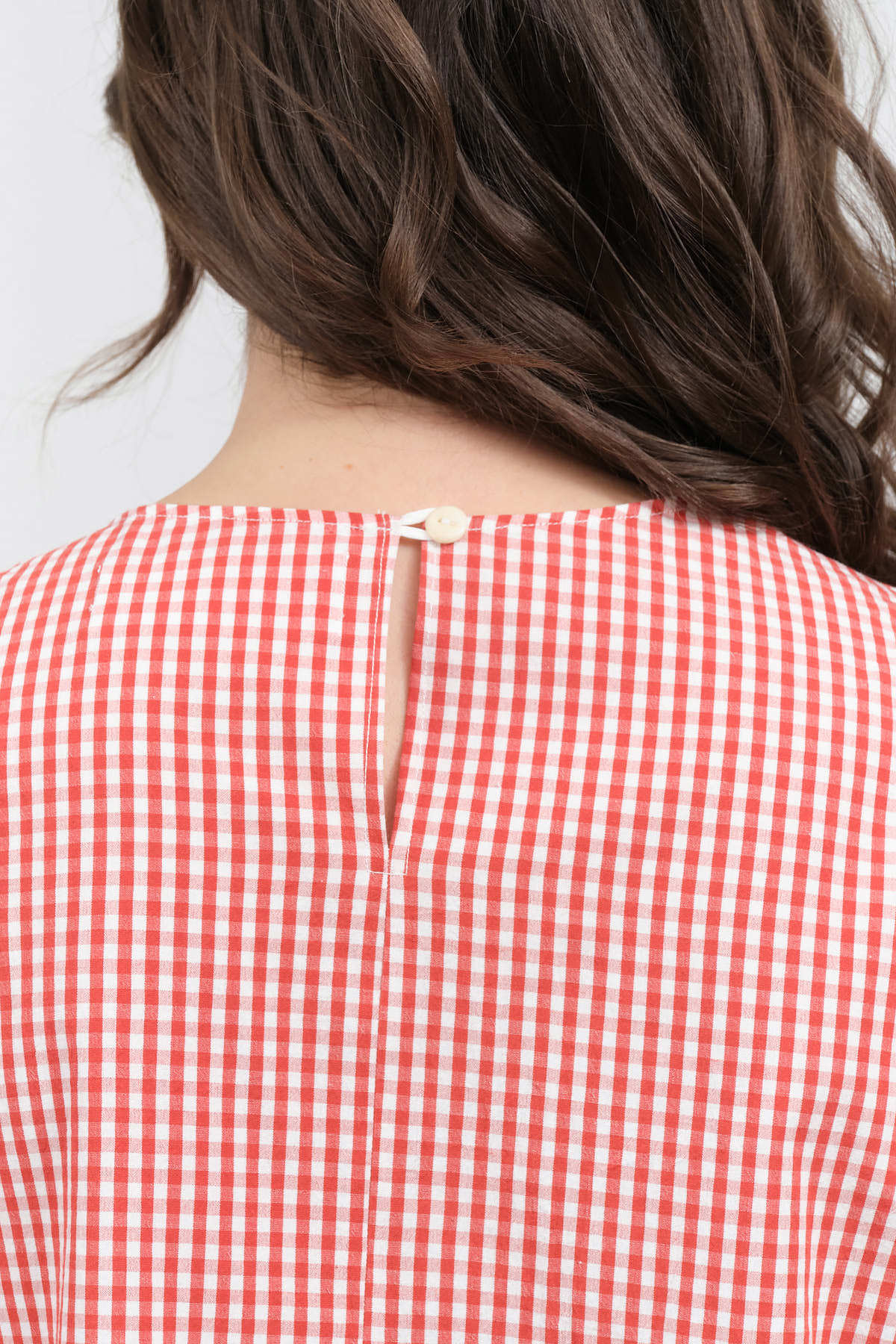 Button closure view of Calita Blouse in Red Gingham