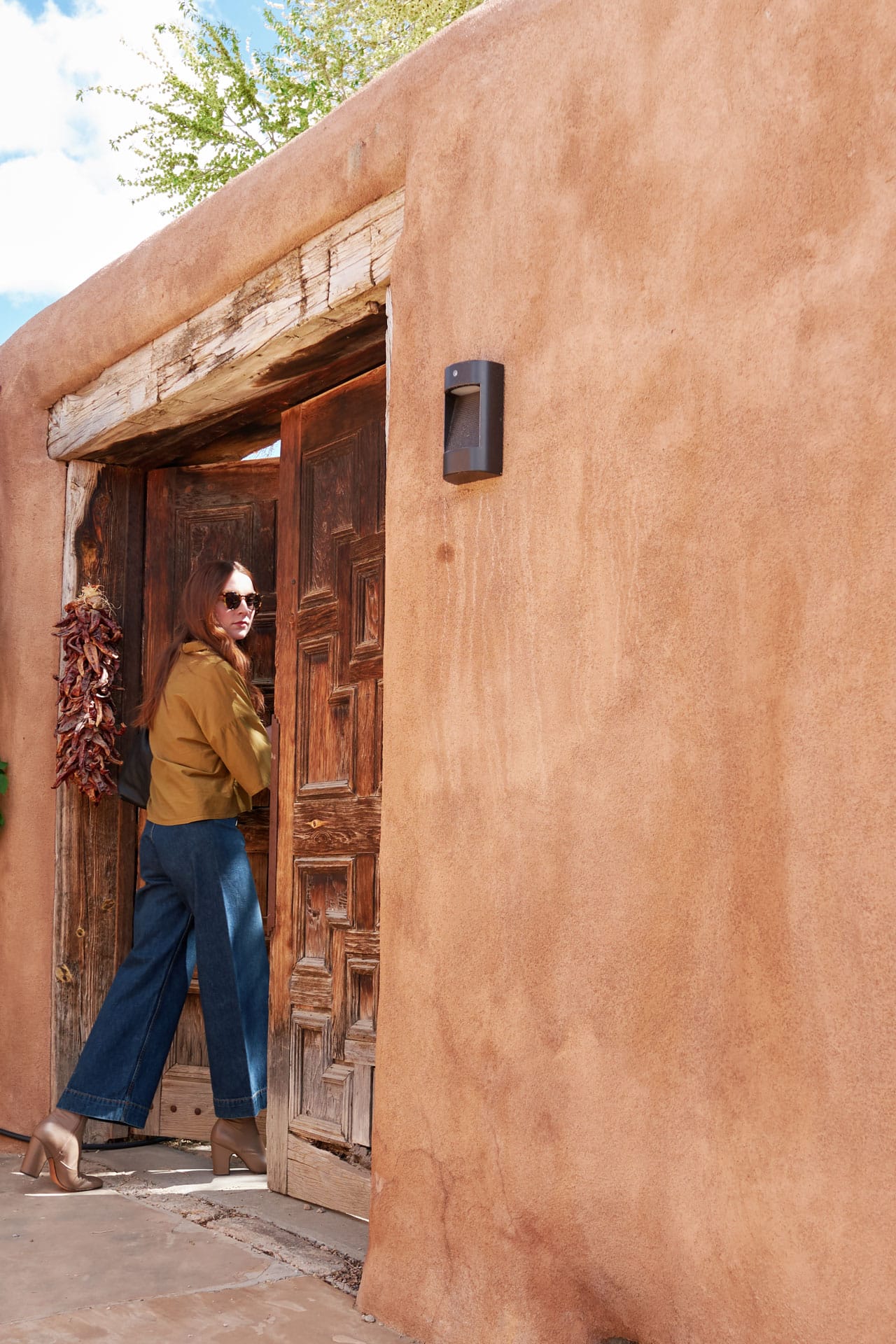 Woman wearing Jesse Kamm Sailor Jeans and Black Crane Top traveling in Santa Fe. 