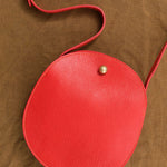 Persimmon Red Round Eggi Bag by Lindquist with Long Strap and Brass Closure