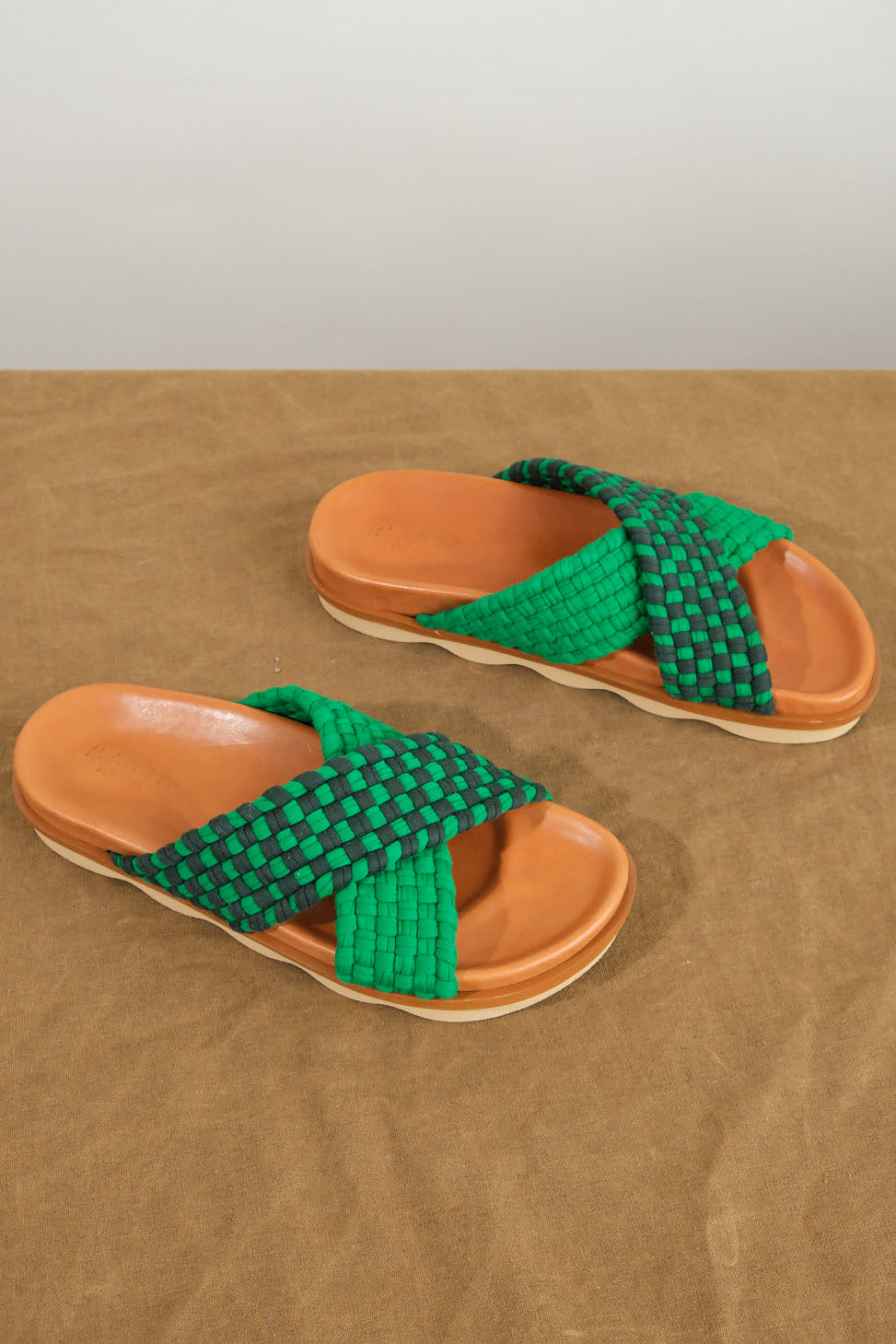 Crossover Wave Sole Sandal in Green/Dark Green on table