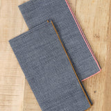 Mi Cocina Dobby Chambray Napkin in Shrimp and O'Keefe Cedar