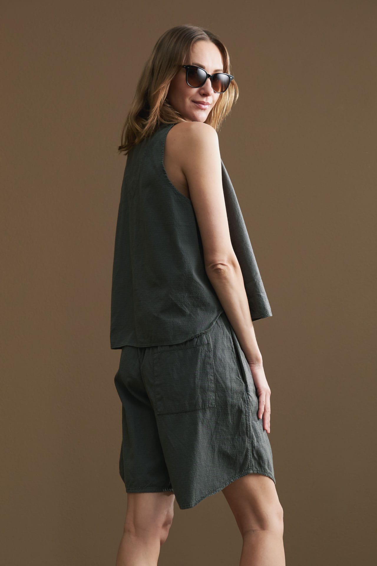 Women wearing organic cotton summer outfit from Wol Hide and sunglasses from Salt optics. 