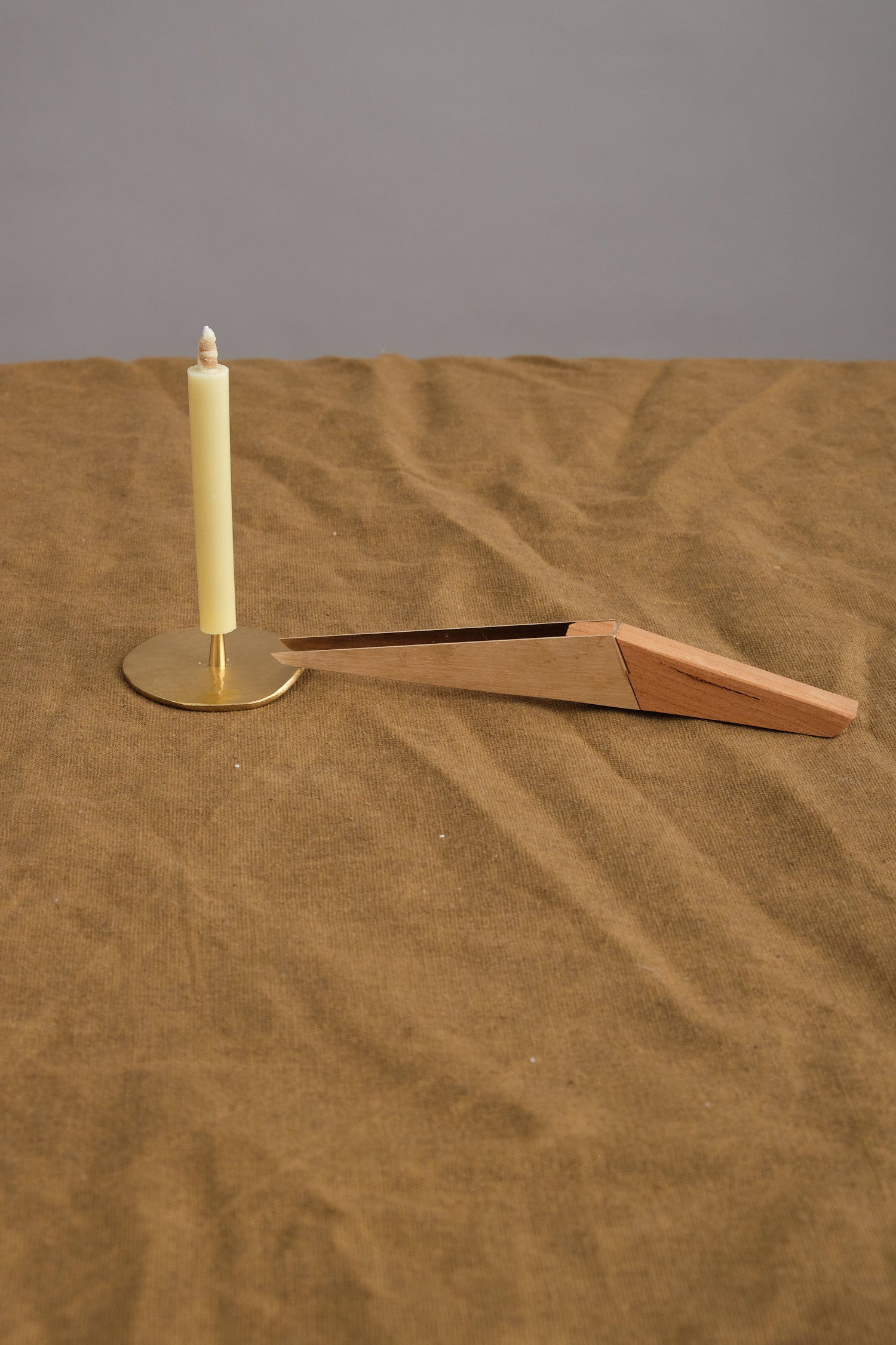 wick trimmer shown with candle
