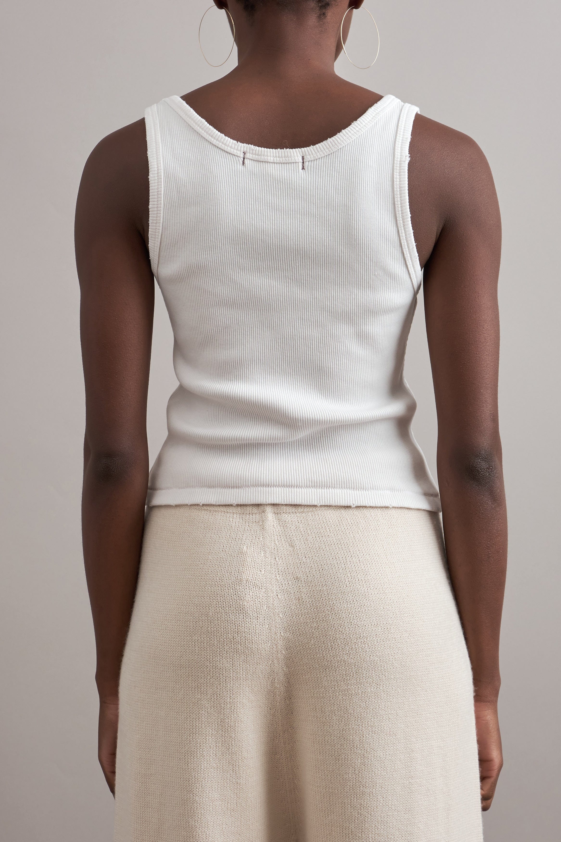 Back view of Amo Denim Crop Rib Tank in Vintage White