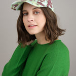 Arat printed cap styled with green Kaliq sweater