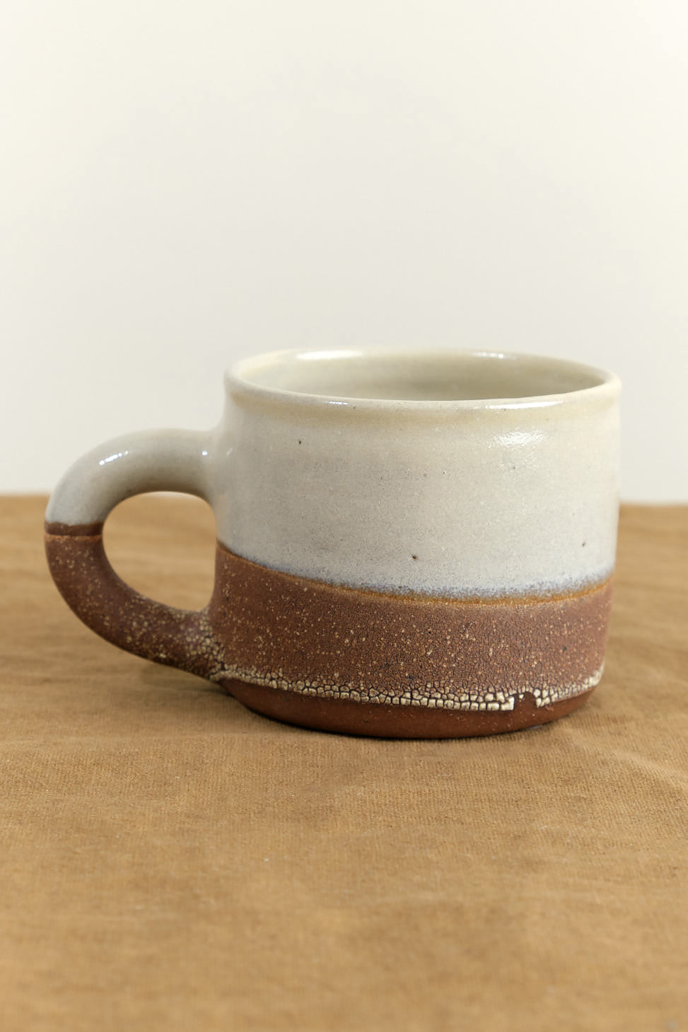 Handle on Stoneware Coffee Mug in Brown Stoneware