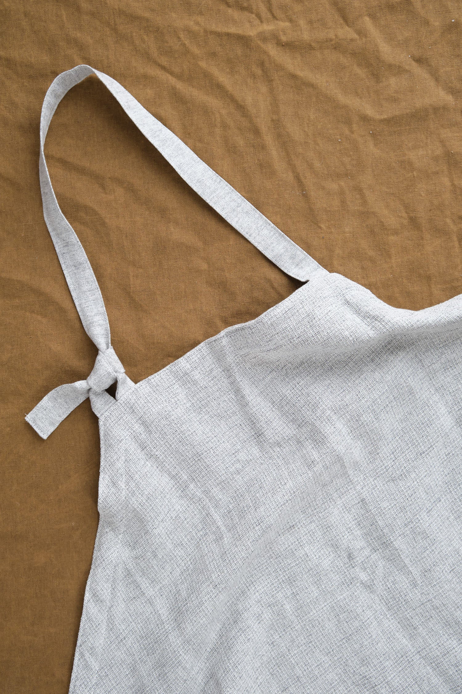 Neck ite on Moku Linen Apron in Charcoal