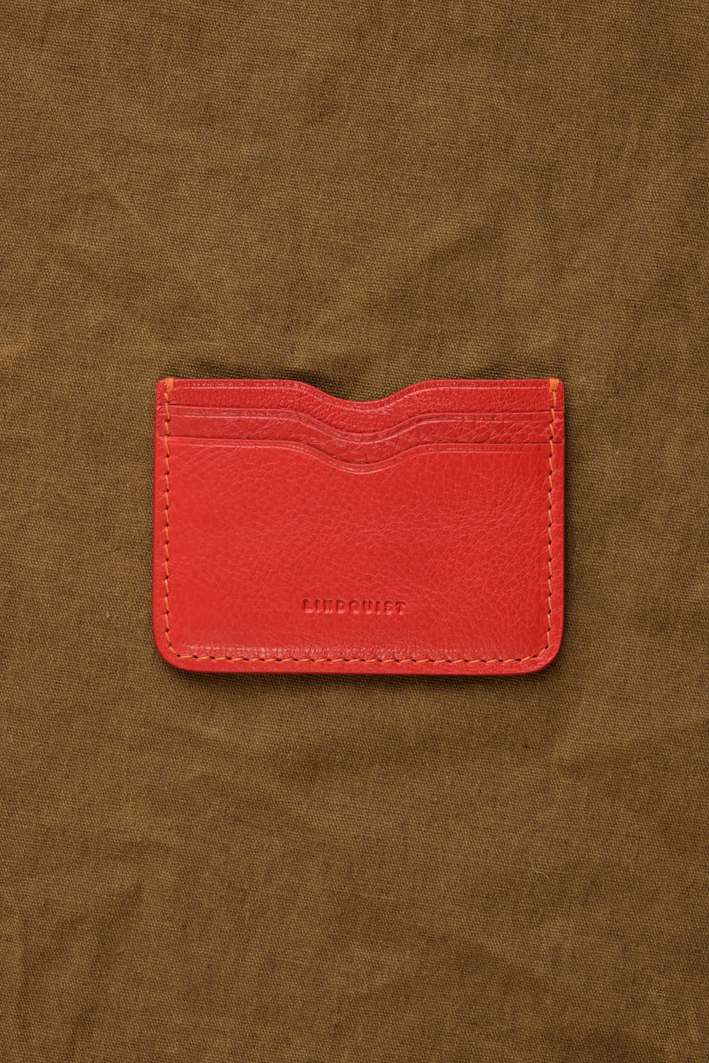 Akira Wallet in Persimmon on table