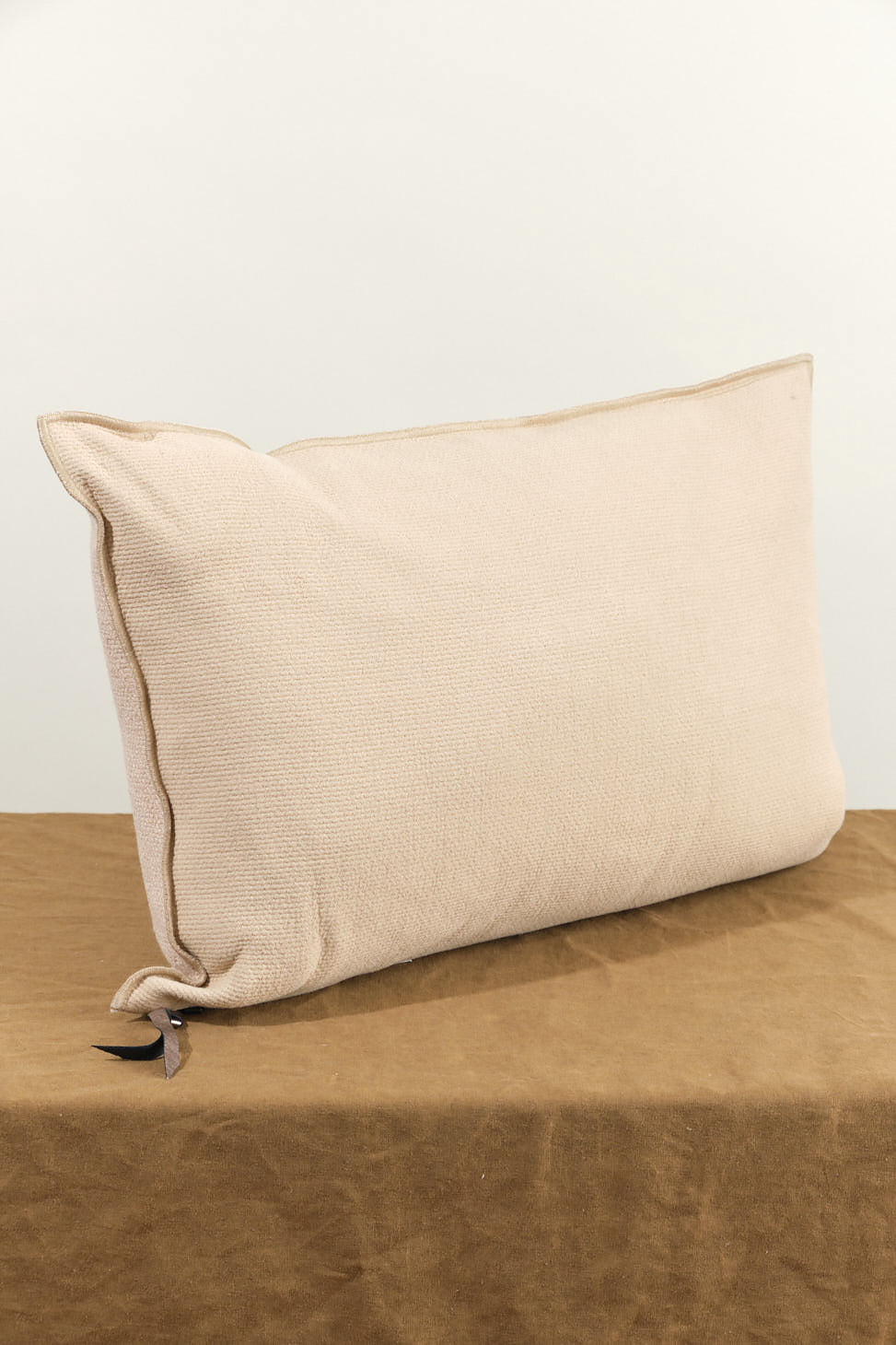 16" X 24" Canvas Vice Versa Cushion in Nude on table