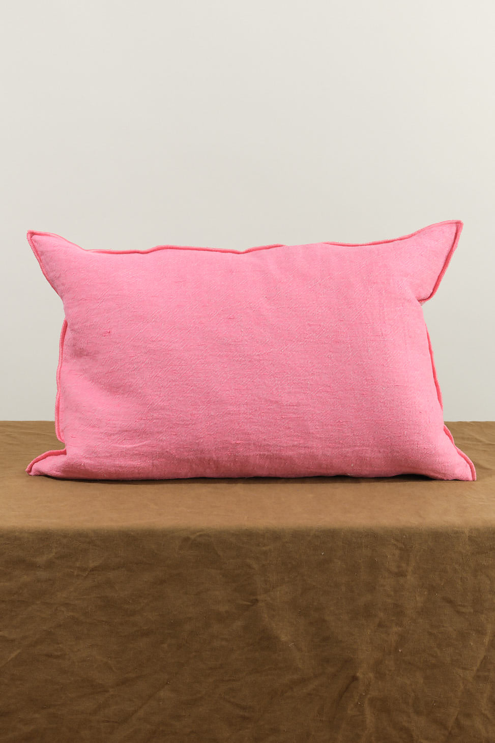 16" X 24" Washed Linen Vise Versa Cushion in Bonbon on table