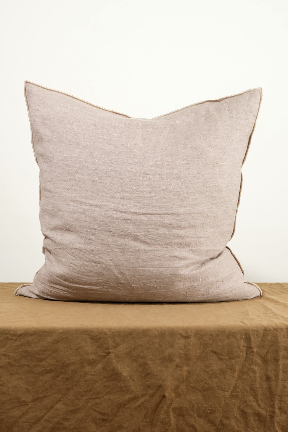 26" X 26" Crumpled Washed Linen Vice Versa Cushion in Taupe on table