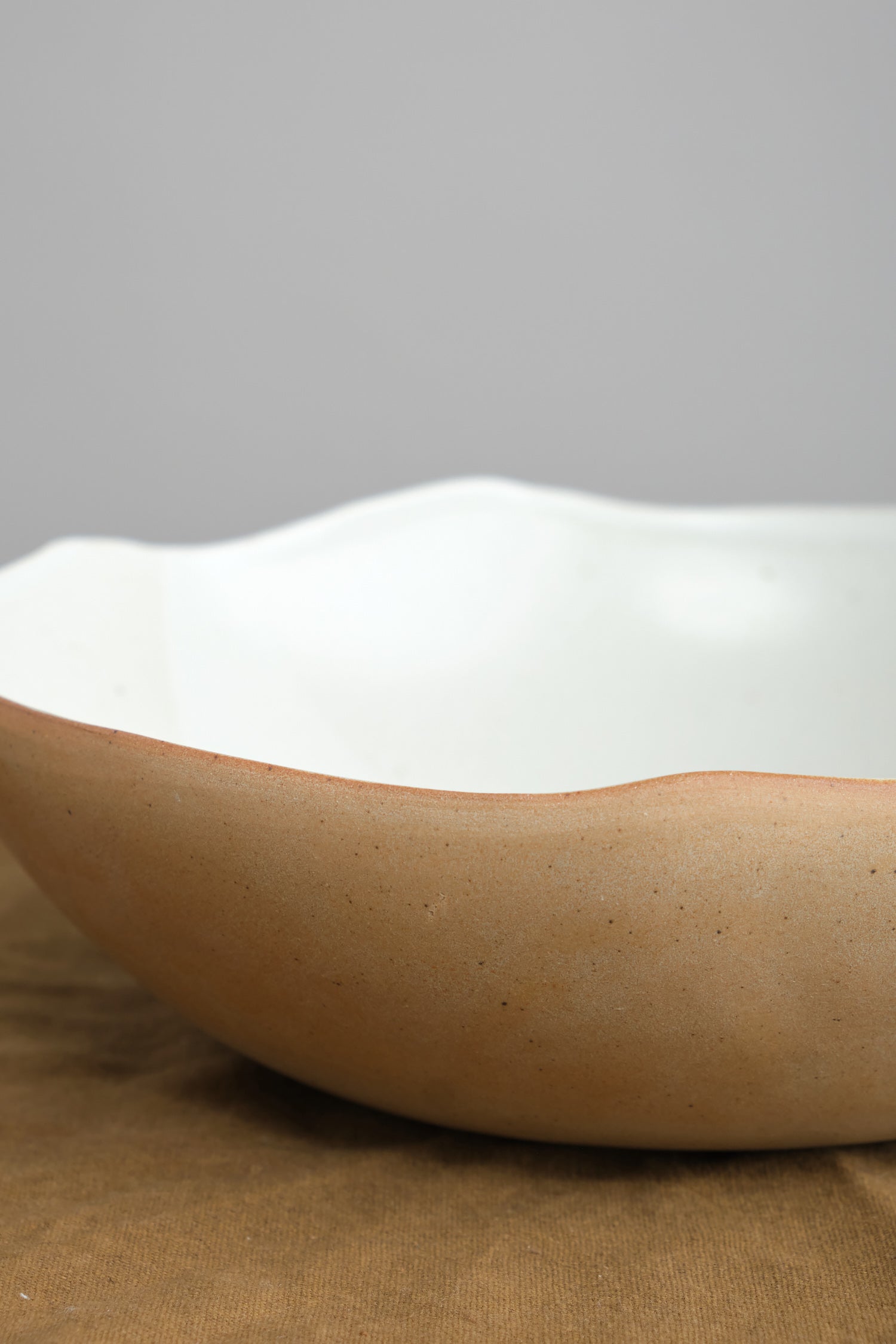 Side of Carved Eggshell Serving Bowl in Naked White